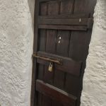 A heavy old wooden door, the threshold where a child learned to read what waited on the other side