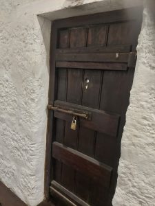 A heavy old wooden door, the threshold where a child learned to read what waited on the other side